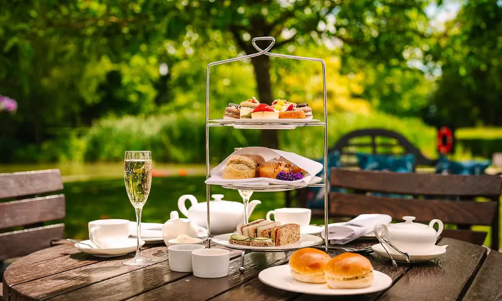 an afternoon tea set up in a garden