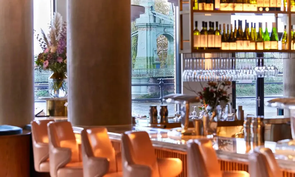 a stylish bar with riverside views