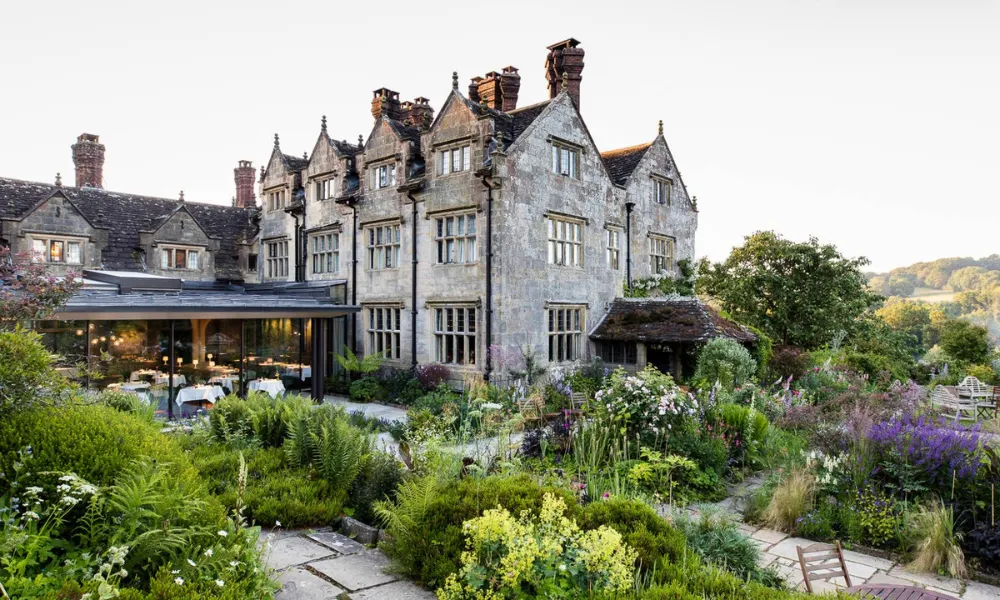 old manor house with pretty garden and glass room