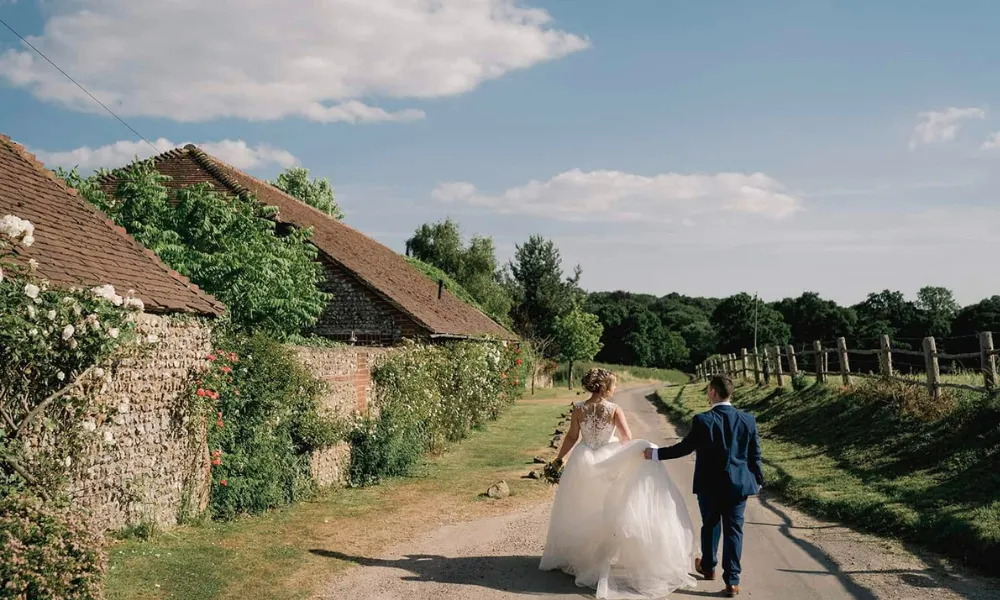 bride and groom next to West sussex barn wedding venue