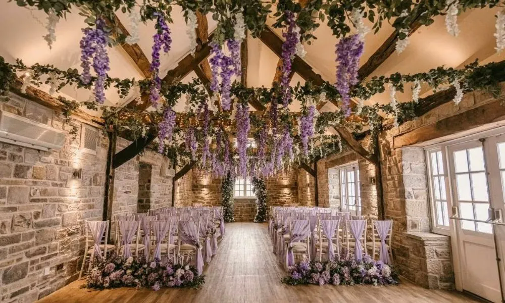 a wedding ceremony set up decorated with lavender and other purple foliage
