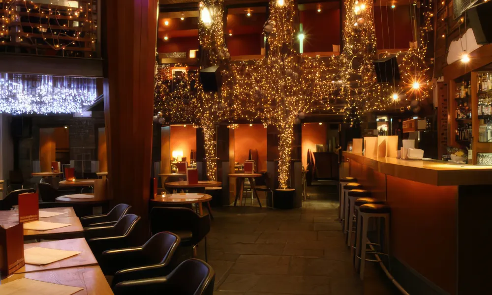 low lit restaurant and bar with fairy lights