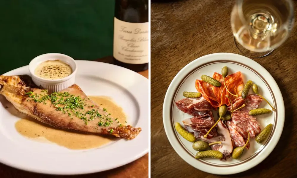 Fish dish in sauce with glass of wine