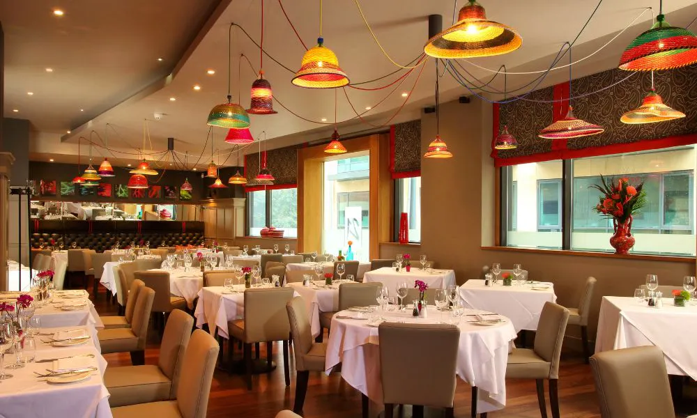 a dining room filled with white-clothed tables