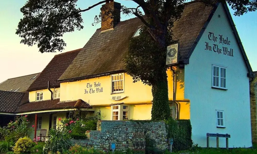 Country pub exterior with rose garden at golden hour