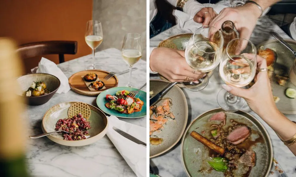 a selection of small plates and people drinking wine
