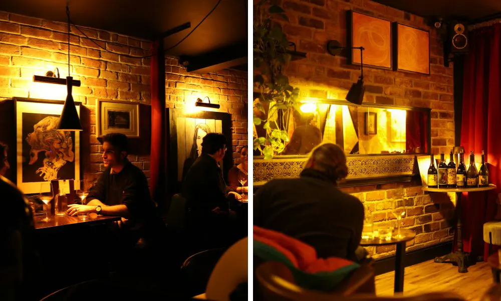 low-lit wine bar interiors with exposed brick and striking artwork 