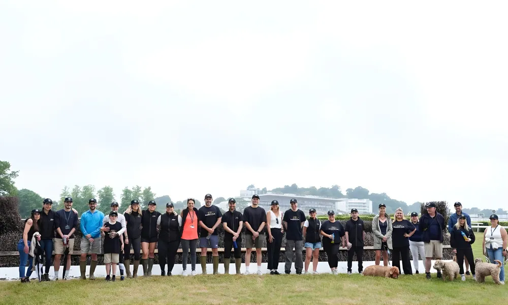 people standing in a row at a race course