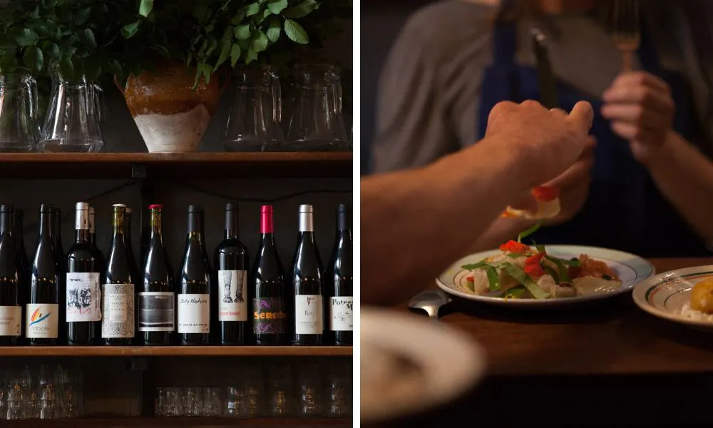 bottles of wine on a shelf and chef trying a dish