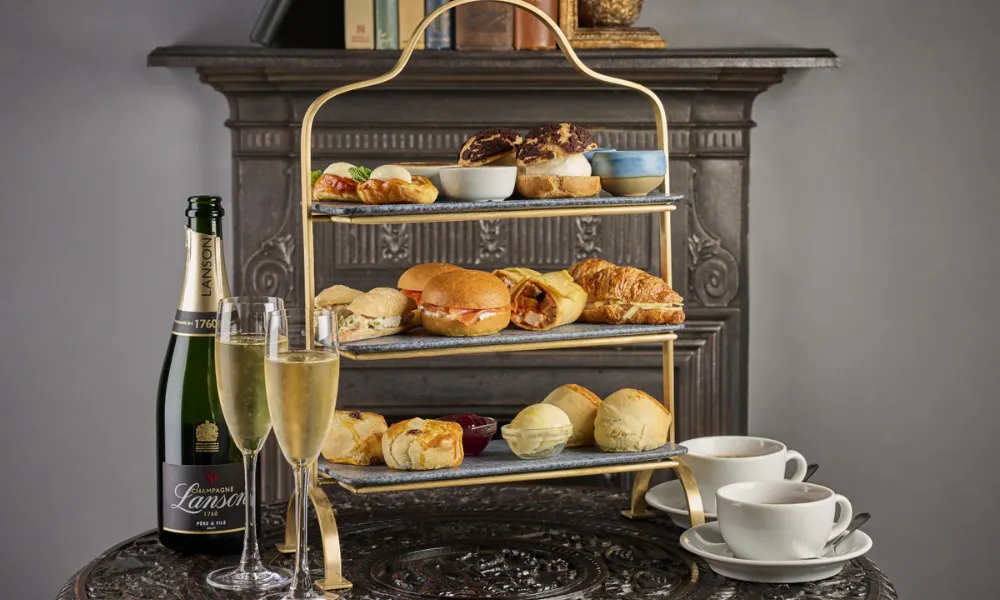 Cakes and sandwiches on silver stand