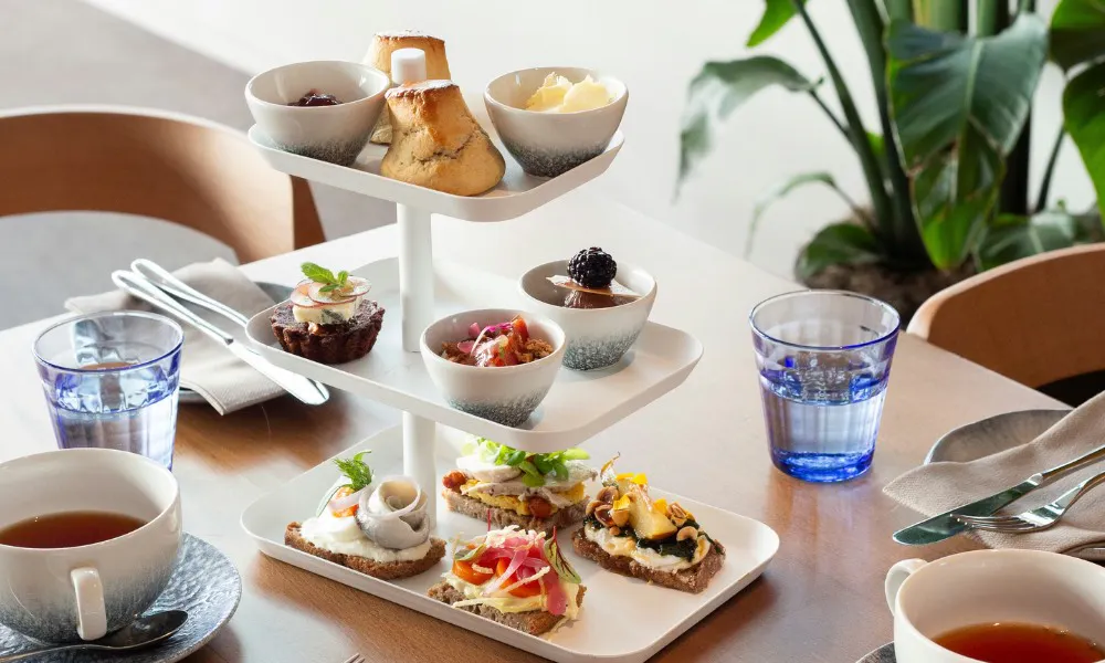 Open sandwiches and sweets on stand