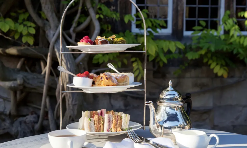 Outdoor afternoon tea set with wisteria behind