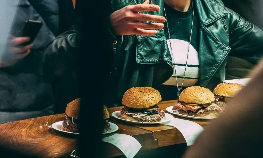burgers on a counter with their kitchen tickets