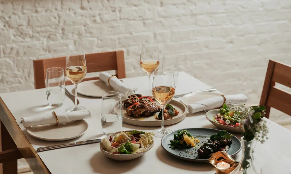 International dishes and white wine on a table
