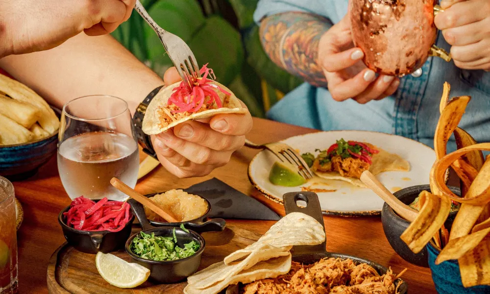 tacos and latin american food and salads on a table
