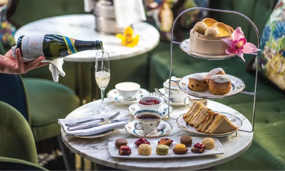 asian inspired afternoon tea with waiter pouring a glass of bubbles