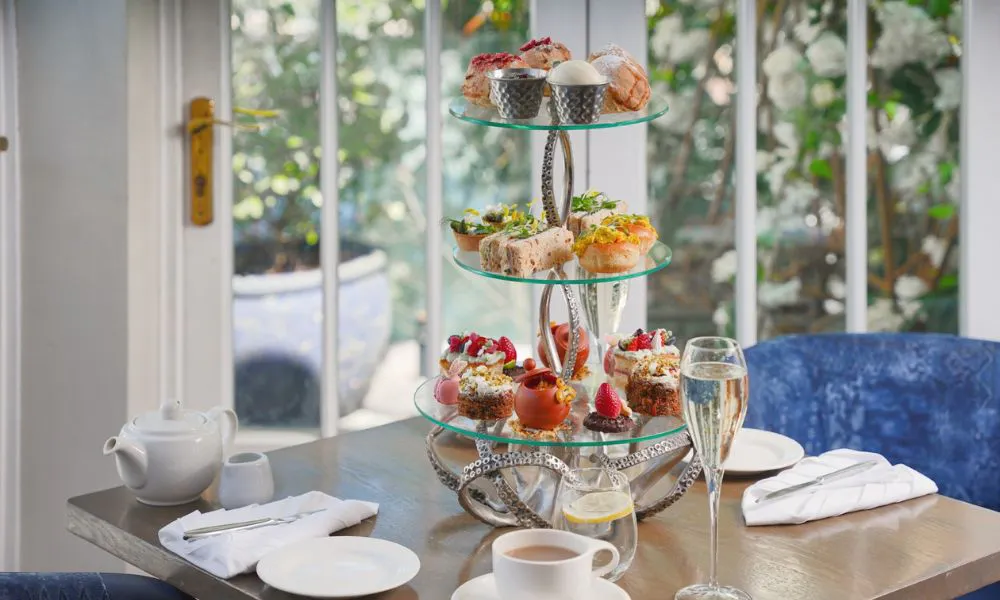 three tiered afternoon tea with glass of bubbles