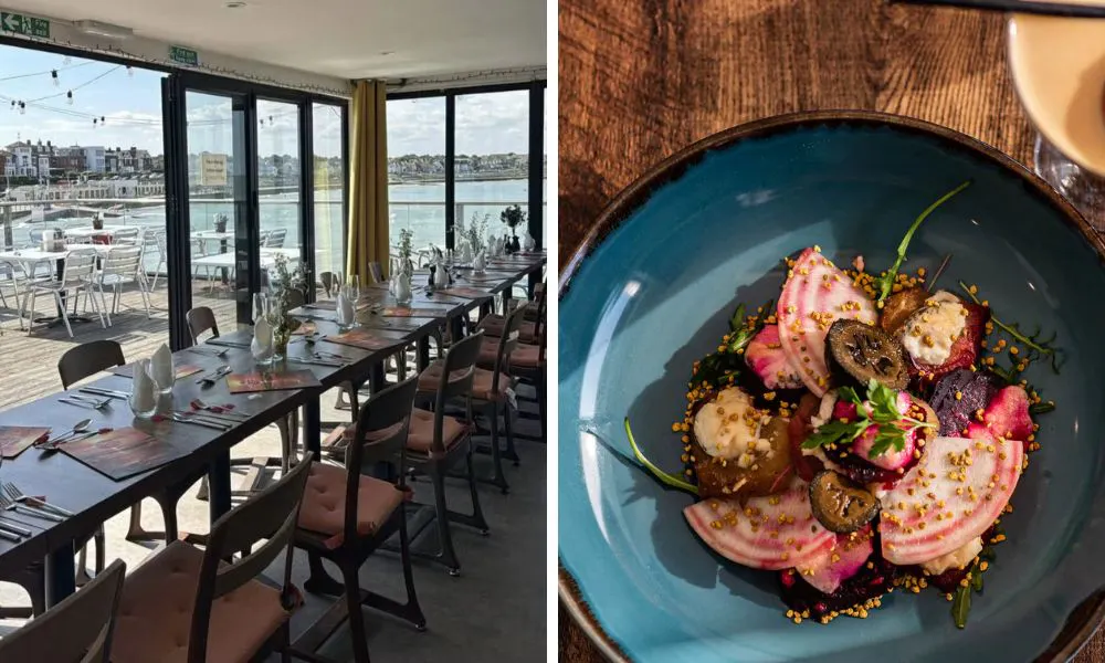 multiple tables set up for service at a restaurant with floor-to-ceilings showing a sea view, and a vegetable-based dish