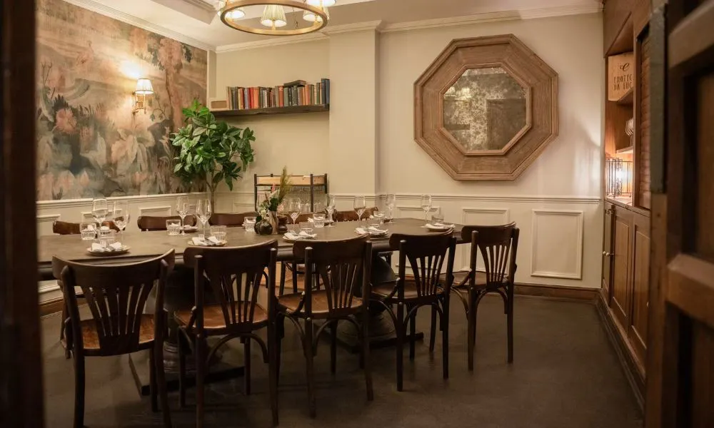 private dining table with bookshelf and wooden panelling