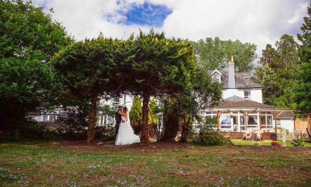 couple under tree outside woodlands hotel