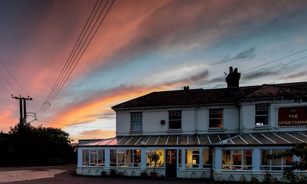 exterior shot of pub with sunset in background