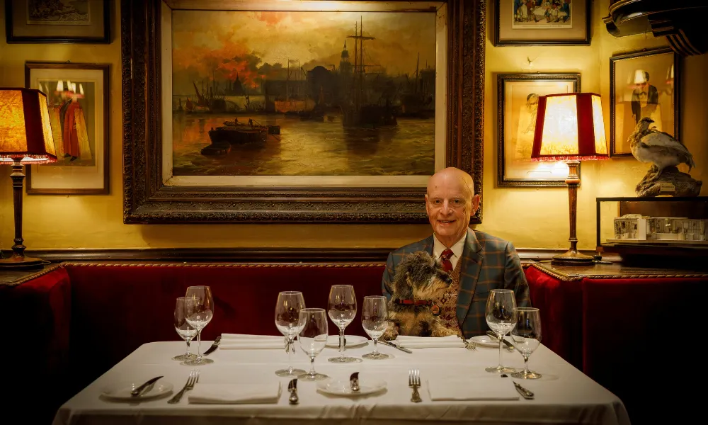 Mayhew pictured at a table in Rules dining room