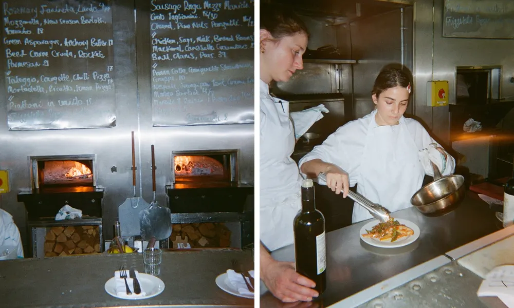 stainless steel counter with pizza ovens behind