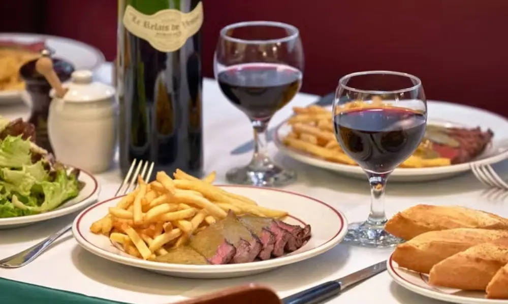 steak frites with herby sauce at entrecote