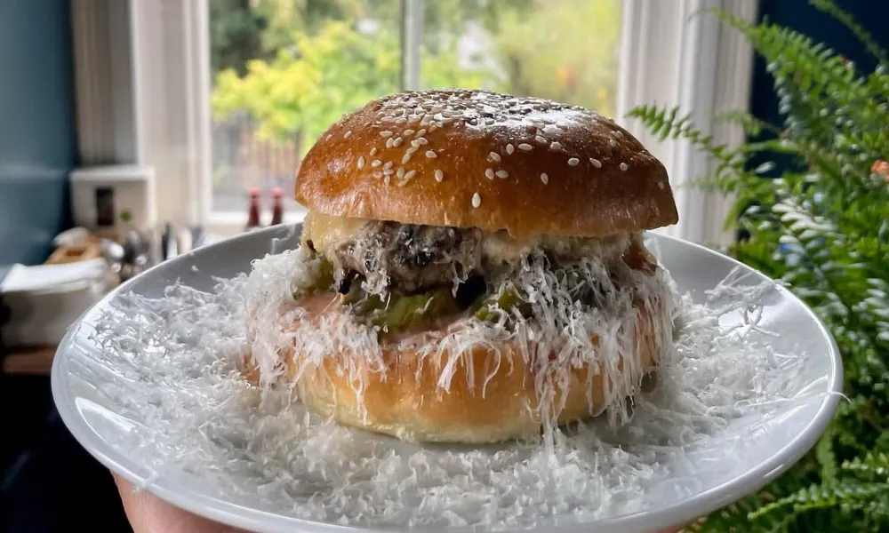 burger in sesame bun with grated cheese