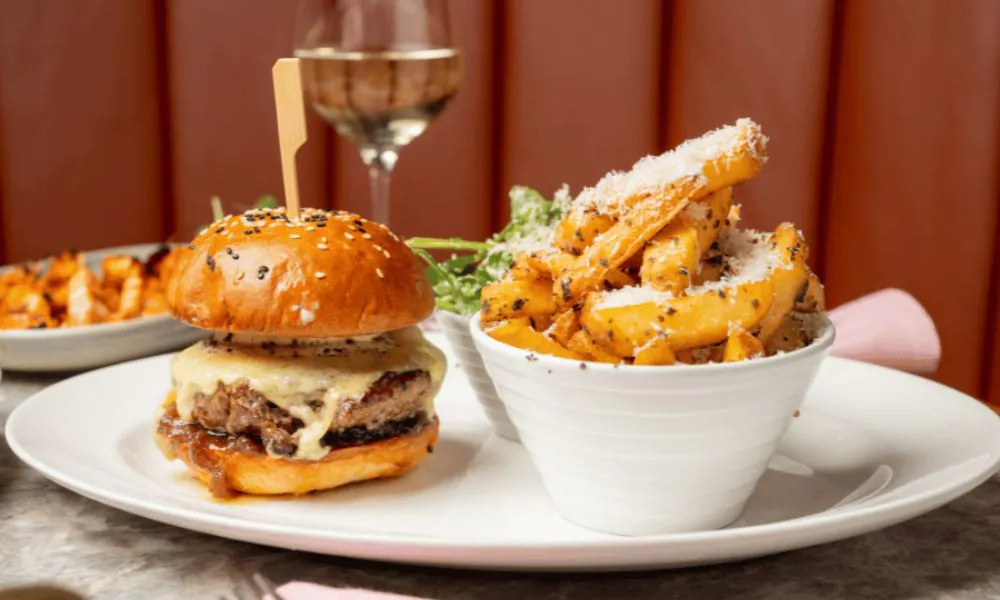 cheeseburger with parmesan fries and glass of white wine