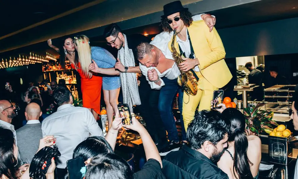 live saxophone and people dancing at penelopes