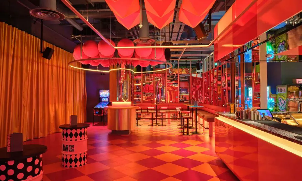 indoor gaming venue with bright colours and bar area