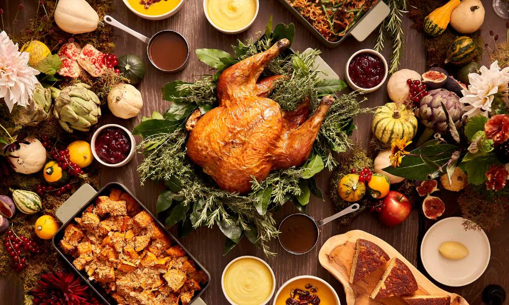 a roast turkey on a table with all of the trimmings