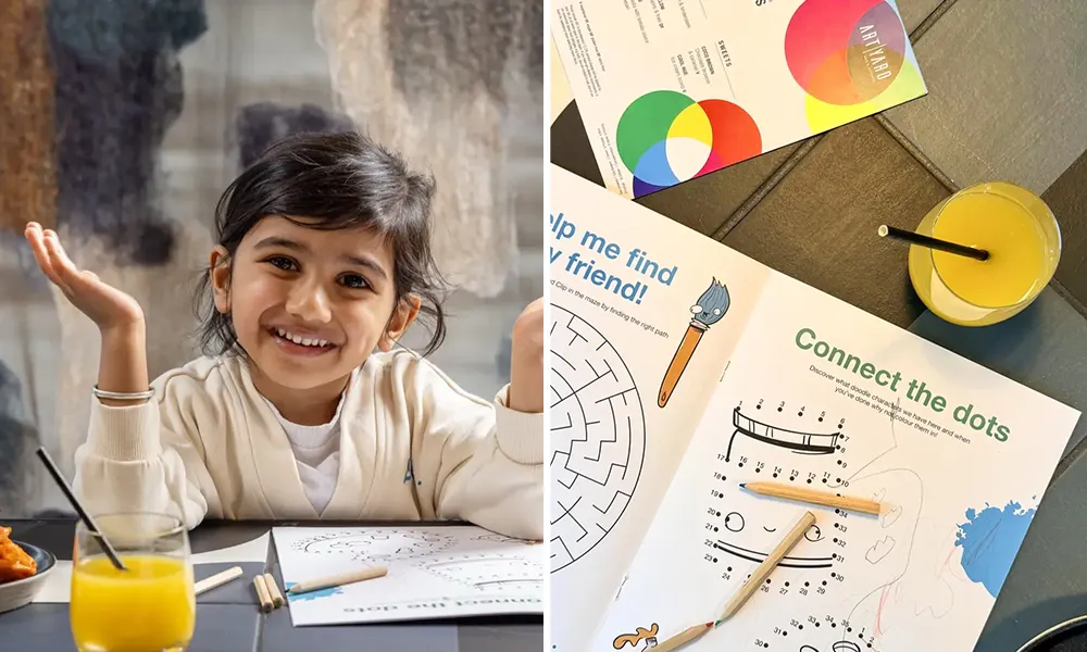 Child at the table with colouring