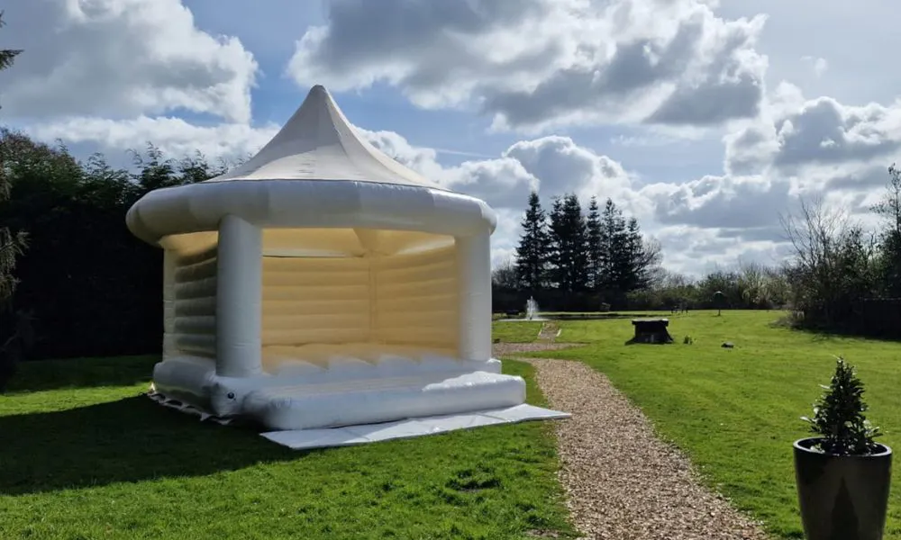 white bouncy castle on a lawn