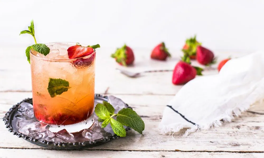 summery pink cocktail with strawberries