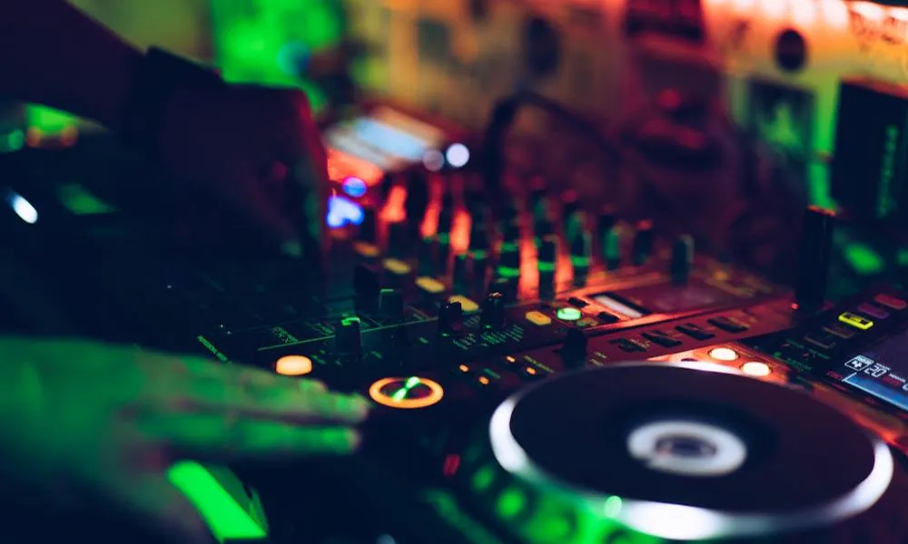 close up of DJ deck lit with green lights