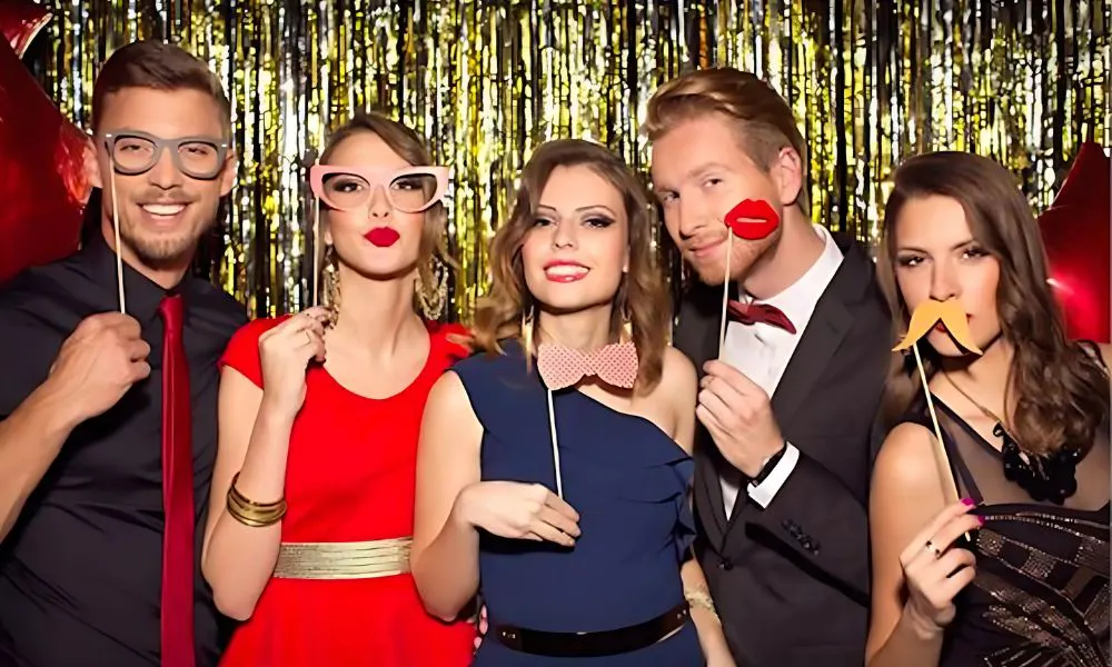 wedding guests pose for picture with props