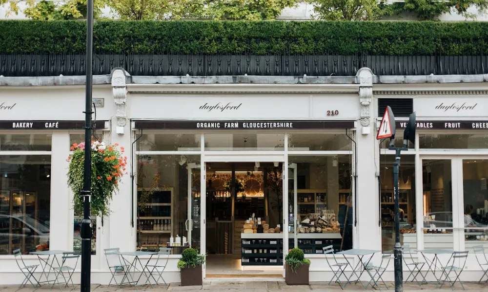 White cafe shop front with a few tables