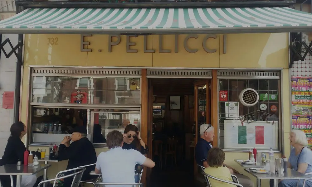 Traditional greasy spoon shop front with tables outside