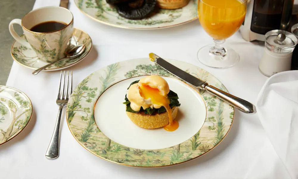 floral plate of eggs florentine with a coffee and orange juice