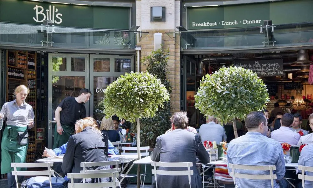 people eating outside a cafe
