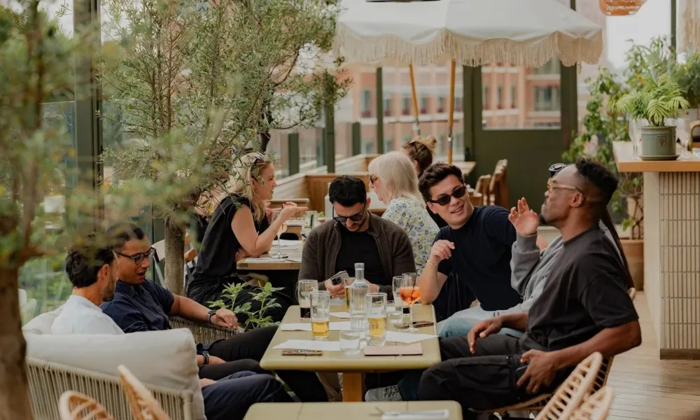 group talking and drinking on the rooftop