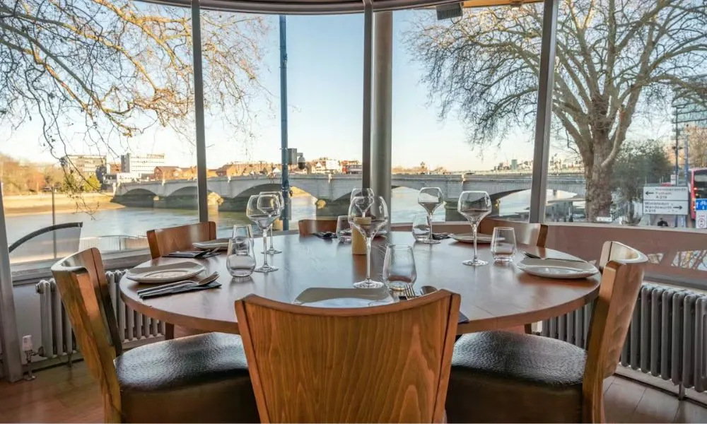 round group dining table overlooking the river thames