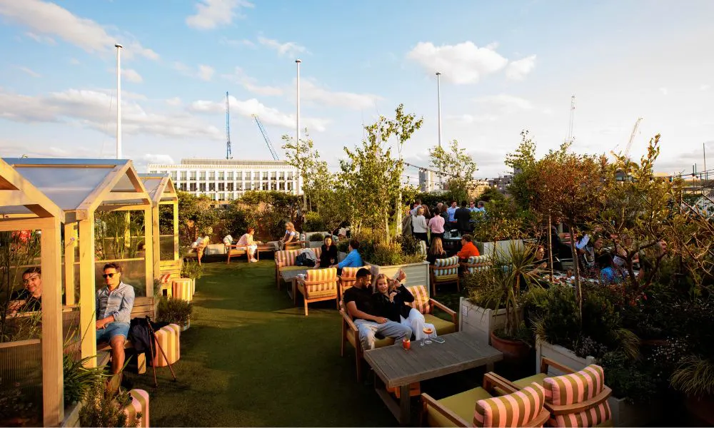 rooftop bar with astroturf and striped chairs