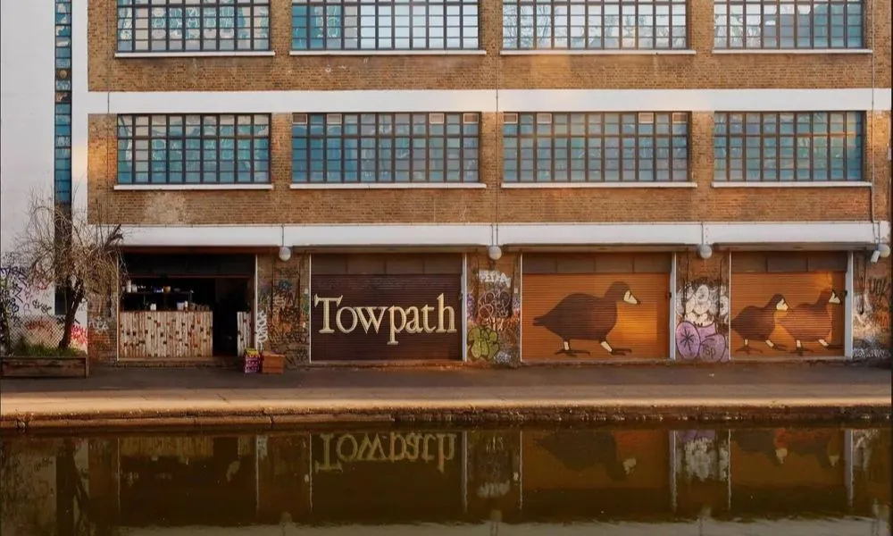 cafe on a canal with painting of a duck on the shutters