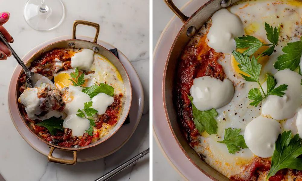 shakshuka topped with greek yoghurt and fresh herbs