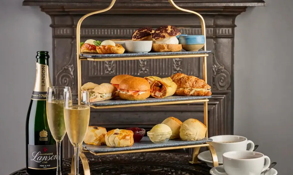 Afternoon tea with choux buns and sparkling wine