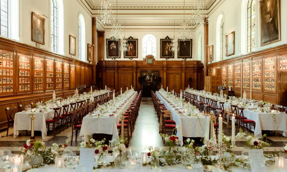 four rows of long decorated rectangular tables with wooden seats