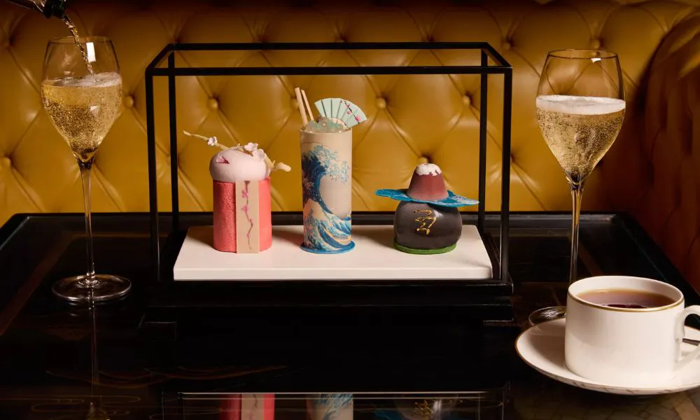artistic cakes on a stand with tea and champagne